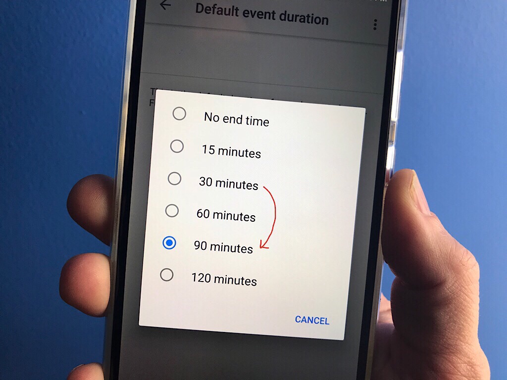 Photo of hand holding Android phone, with Google Calendar default event length options show (arrow indicates changing from 30 minutes to 90 minutes)