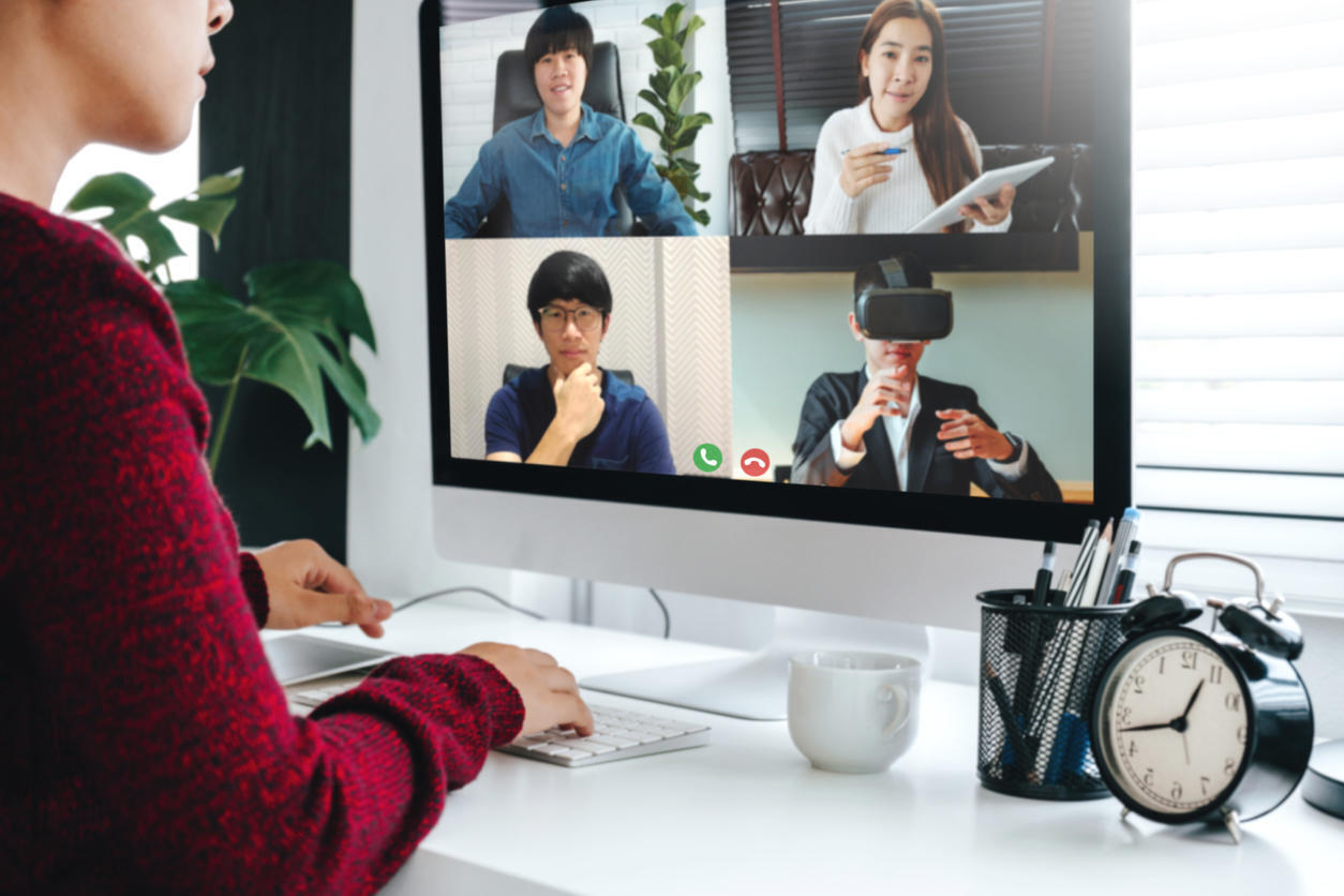 Asian Woman working from home use Smart working and video conference online meeting with Asian team using laptop and tablet online in video call for new projects
