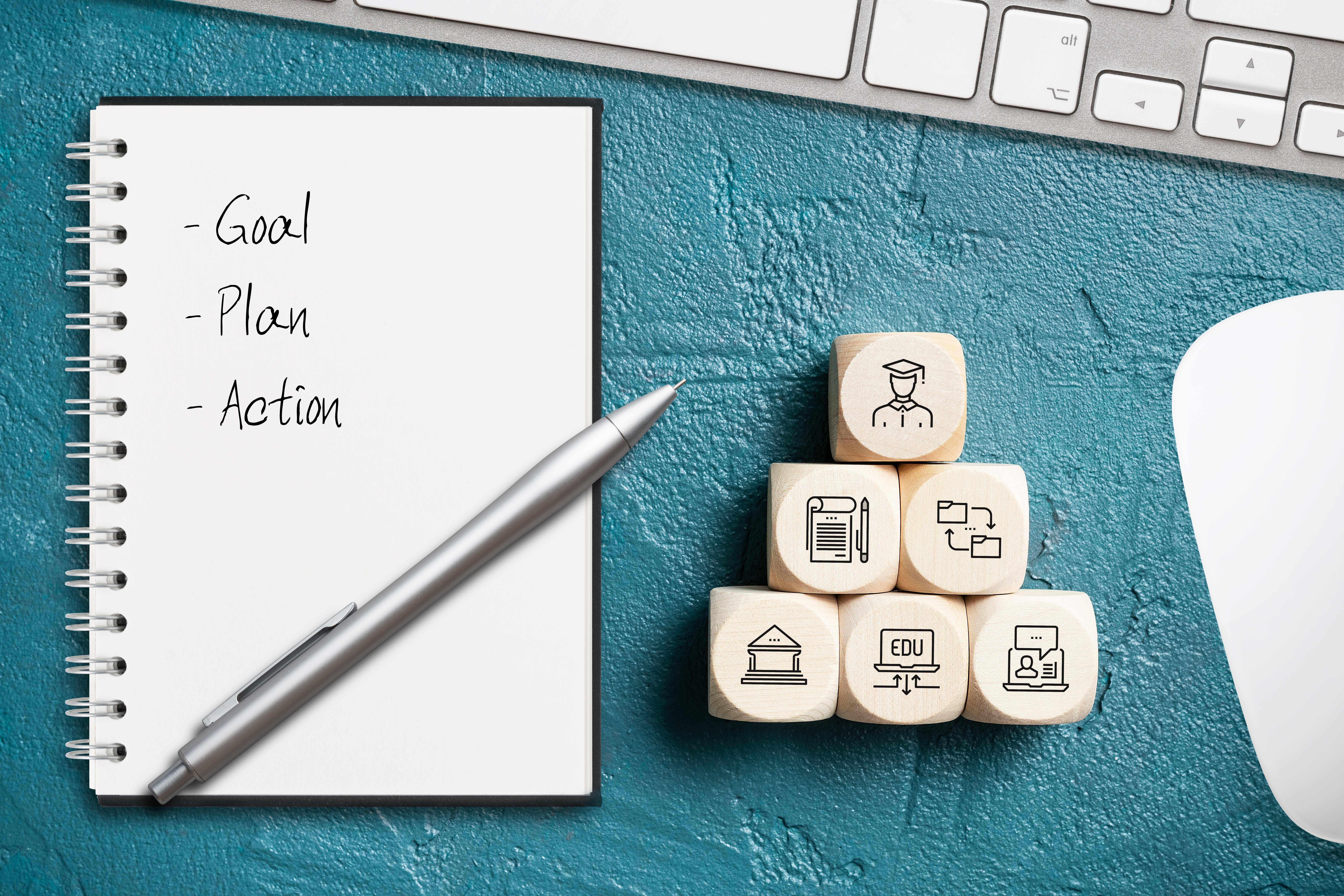 E-Learning concept and notepad with list "goal, plan, action"