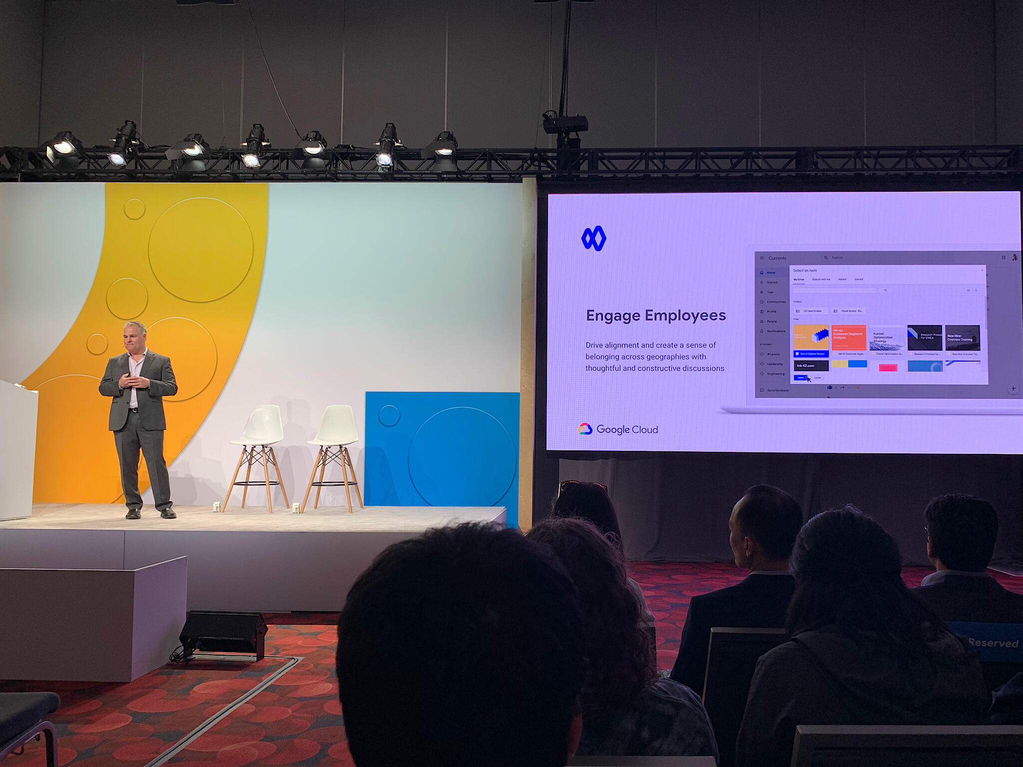 Photo of Google staff (standing on stage, left) with presentation slide of Currents with "Engage Employees" displayed (right)