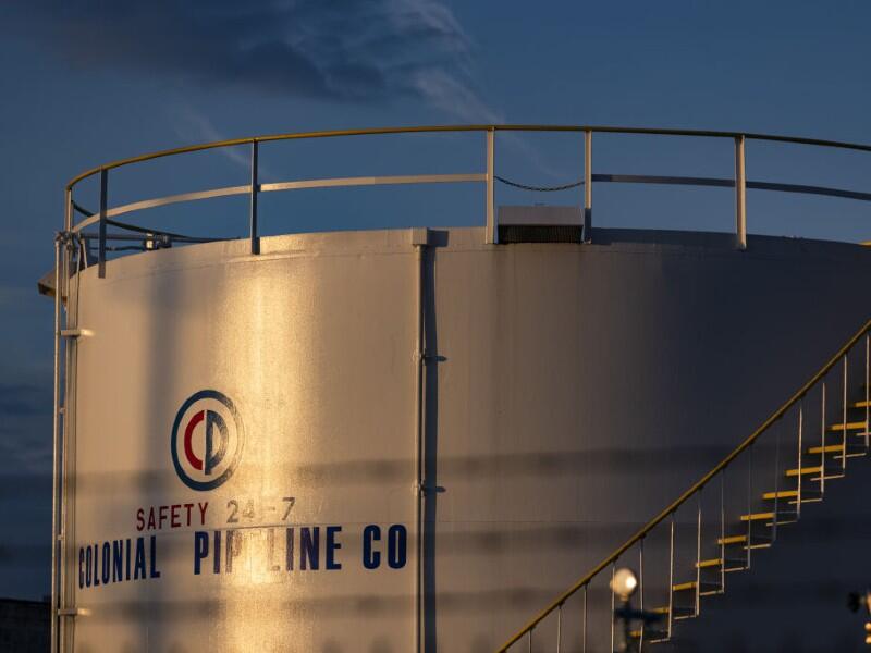 A Colonial Pipeline tank at dusk