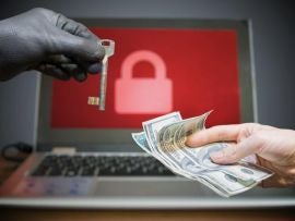 Computer security and hacking concept. Ransomware virus has encrypted data in laptop. Hacker is offering key to unlock encrypted data for money.