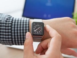 Man hand with Apple Watch and Macbook on the desk