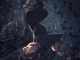Pixelated unrecognizable hooded cyber criminal