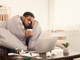 Man feeling sick while working from home