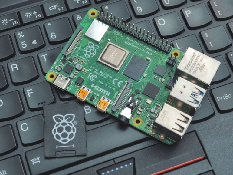 Close-up of a Raspberry Pi 4 Model-B on a laptop keyboard. The Raspberry Pi is a credit-card-sized single-board computer developed in the UK