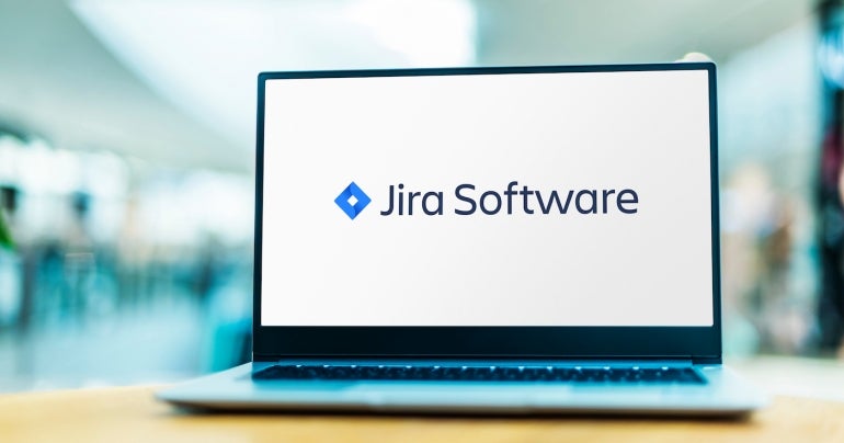 Laptop computer displaying logo of Jira