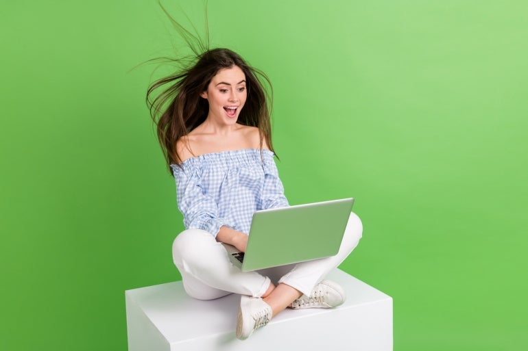 Photo of adorable excited amazed girl see big sale discount on black friday shopping bargain isolated on green color background.
