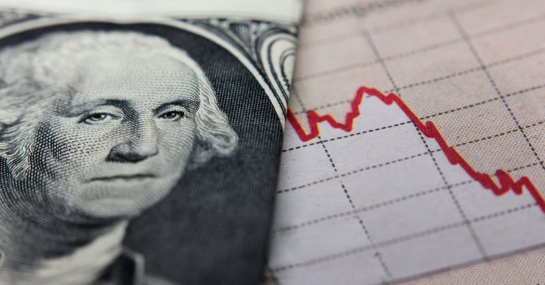 Stock market chart next to a $1 bill (showing former President Washington).  The red trend line indicates the recession in the stock markets.