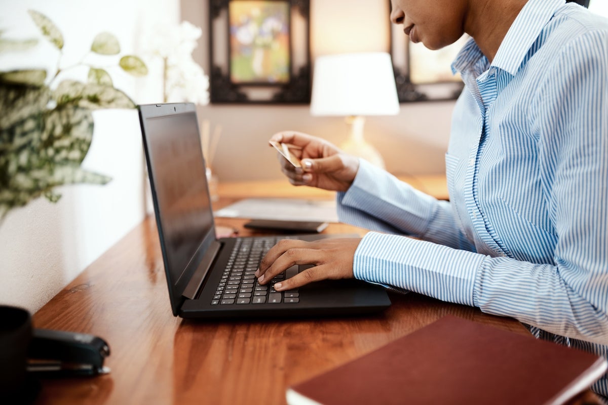 Cropped shot of a businesswoman using a laptop and credit card.