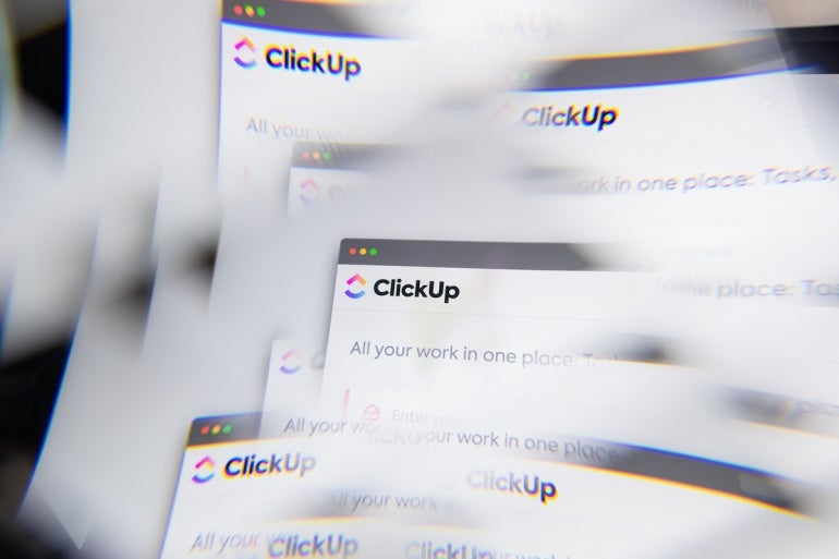 Milan, Italy - APRIL 10, 2021: ClickUp logo on laptop screen seen through an optical prism. Illustrative editorial image from ClickUp website.