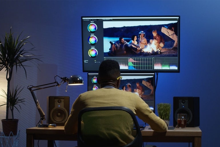 man editing videos on a computer