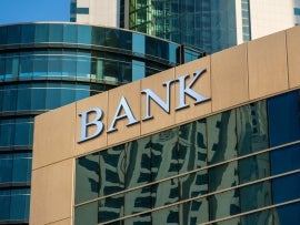 Bank sign on glass wall of business center.