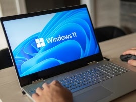 Windows 11 logo on laptop screen.