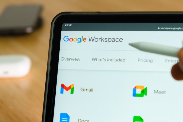 Google Workspace logo shown by apple pencil on the iPad Pro tablet screen. Man using application on the tablet. December 2020, San Francisco, USA.