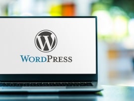 Laptop computer displaying logo of WordPress.