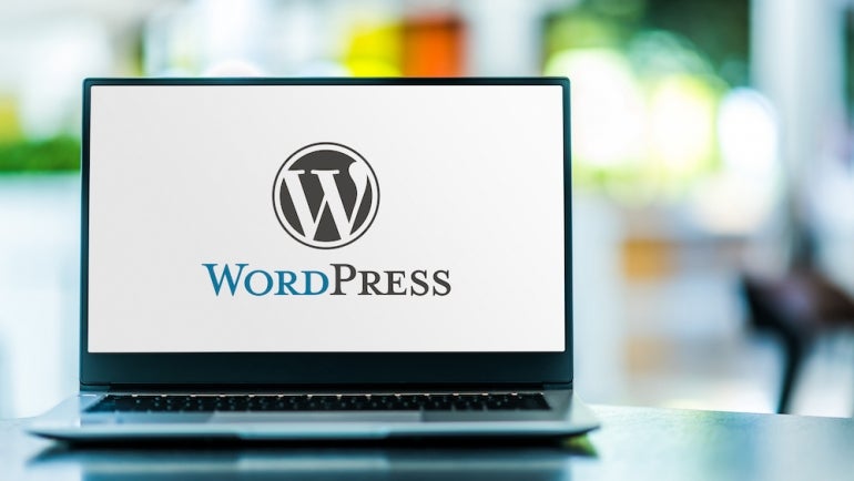 Laptop computer displaying logo of WordPress.