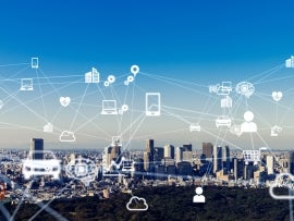 Interconnected Internet of Things icons over a city.