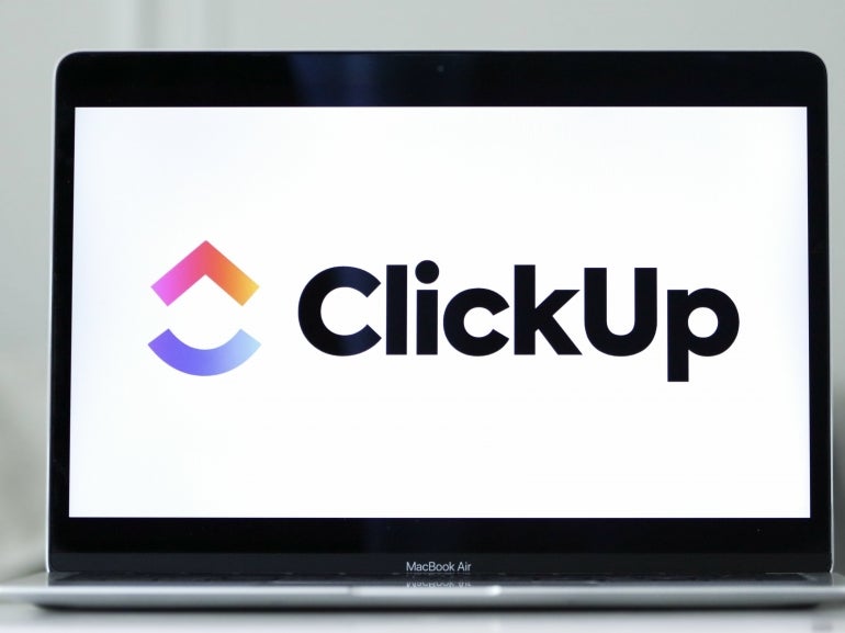Logo of ClickUp presented on a laptop screen.