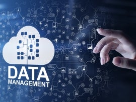 Person touching a "Data Management" cloud symbol on screen.