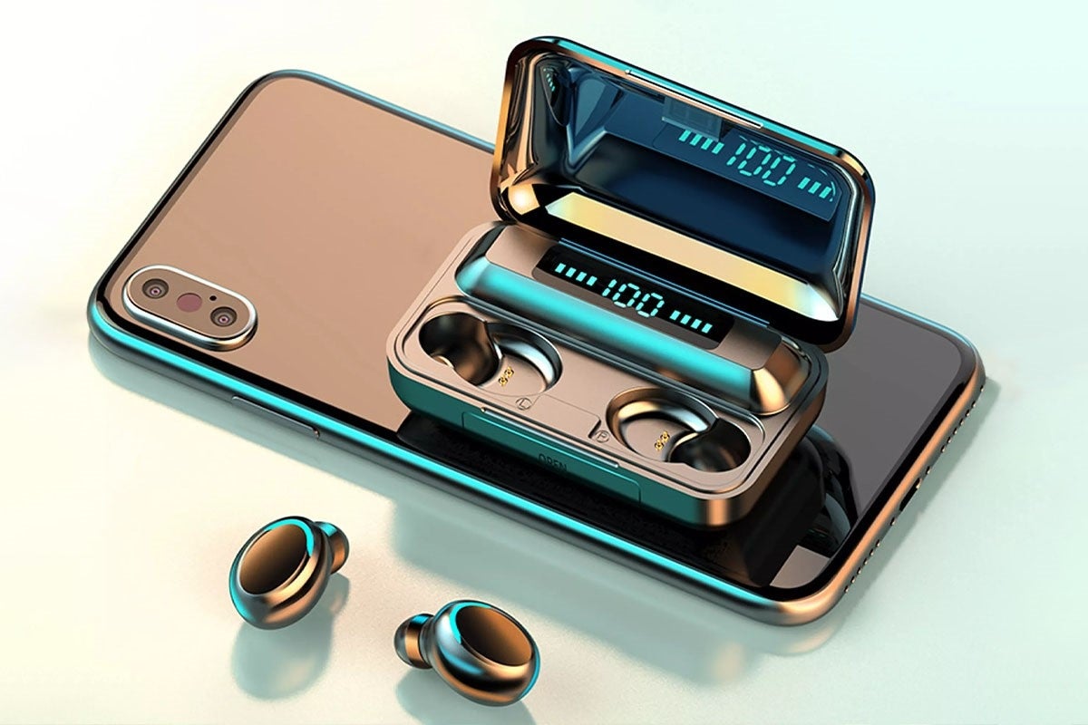Flux 7 TWS earbuds out of the case, which is resting on top of a smartphone