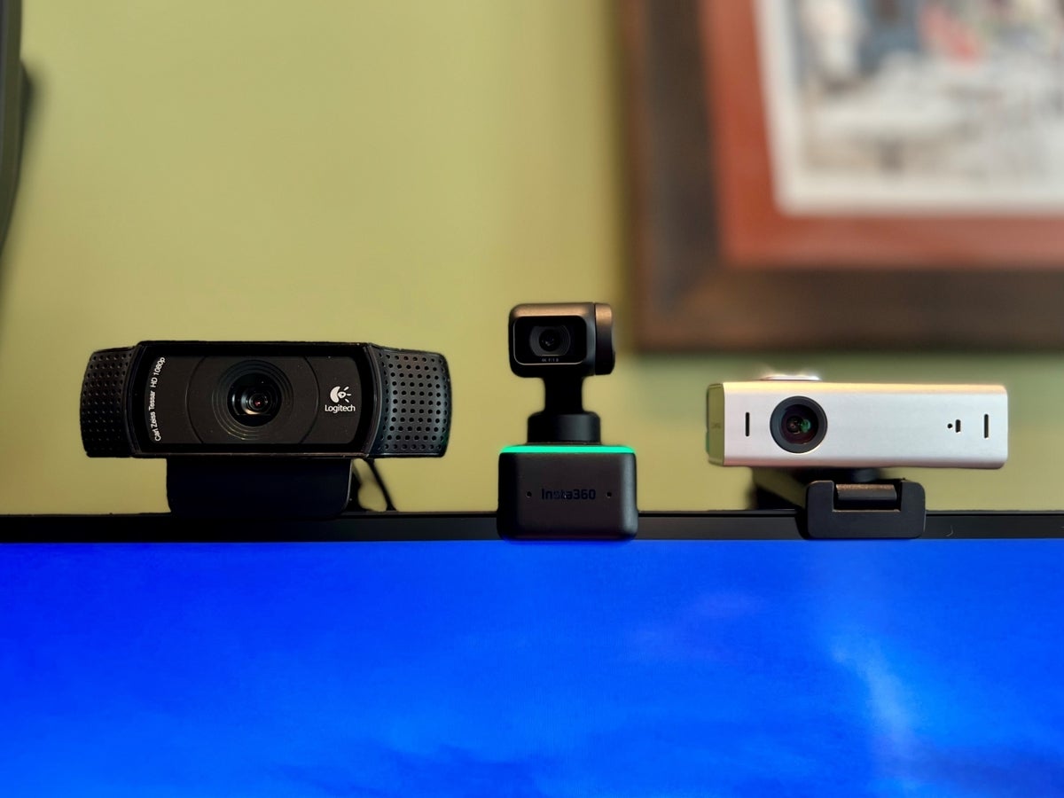 Logitech C920, Insta360 Link, and Lumina 4K resting on top of a computer monitor