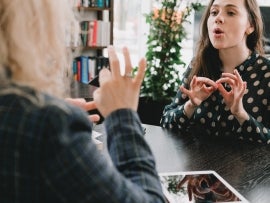 Women communicating in American Sign Language.