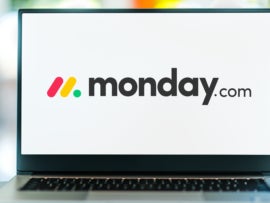 Laptop computer displaying logo of monday.com, a project management tool.