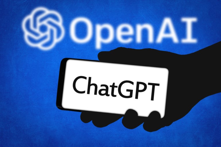 The ChatGPT logo is a phone in front of the OpenAI logo.