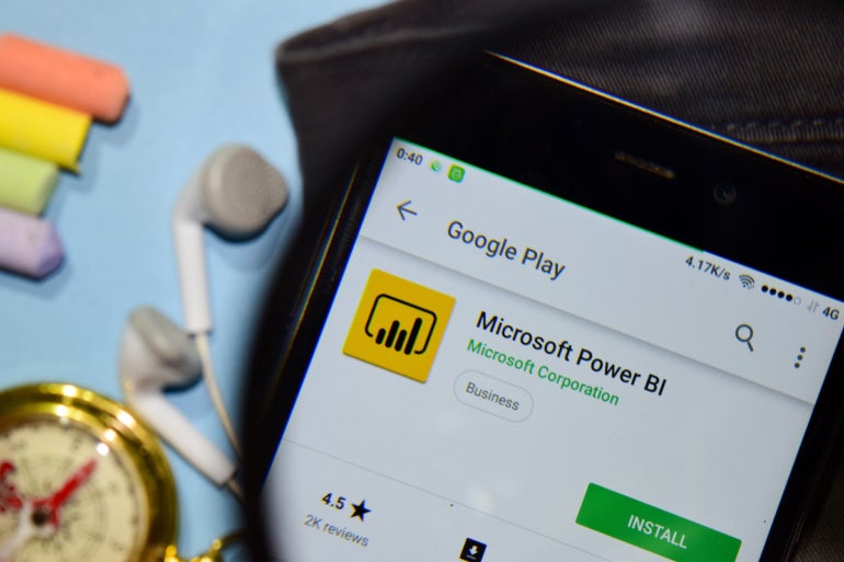 Microsoft Power BI dev app with magnifying on Smartphone screen. Microsoft Power BI is a freeware web browser developed by Microsoft Corporation