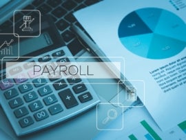 The text payroll over a blue-shaded background of a calculator and data reports