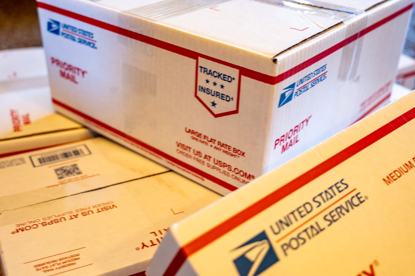 stack of USPS priority mail shipping boxes