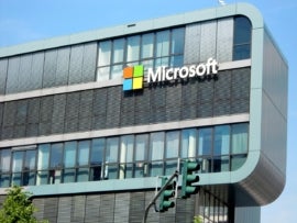 An office building with a Microsoft logo prominently displayed on the outside.