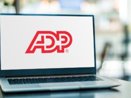 The ADP logo on a laptop.
