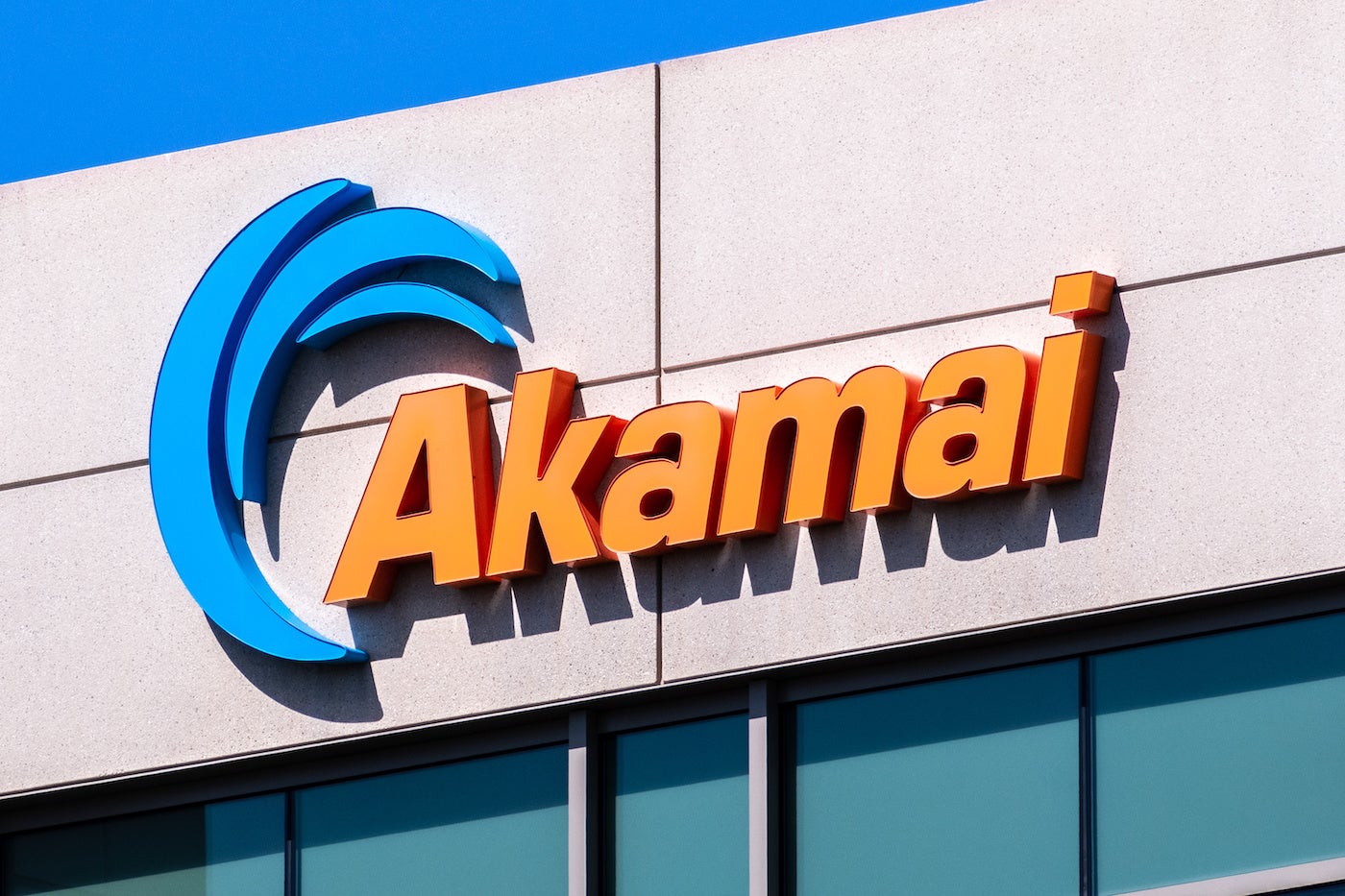 Top of Akamai building with Akamai logo in blue and orage