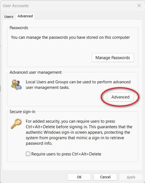 A red circle around the Advanced button in the Advanced user management section of the User Accounts Advanced settings in Windows 11