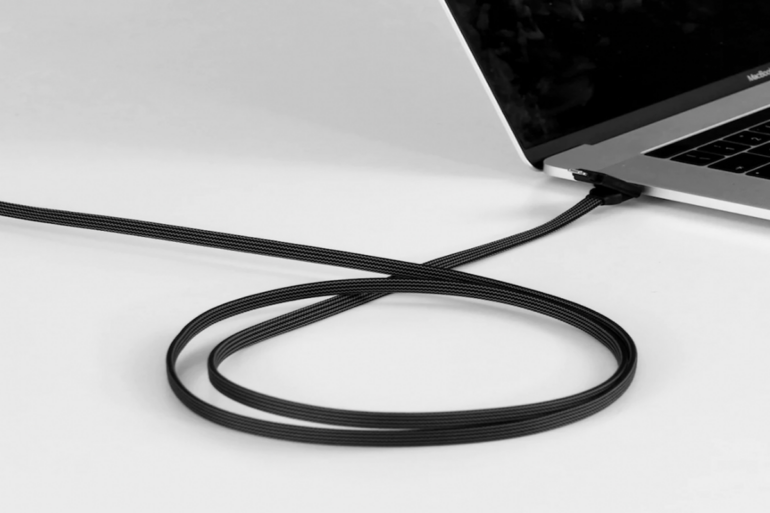 The inCharge X Max 100W Charging Cable connected to a laptop.
