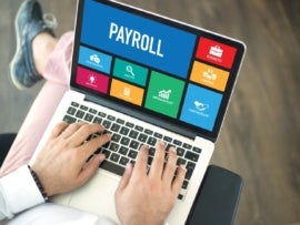 Setting up a payroll software on a laptop.