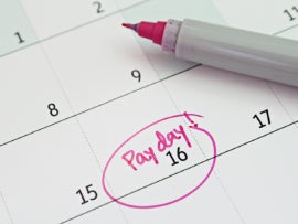 A date on a calendar labeled as payday with a pink marker.