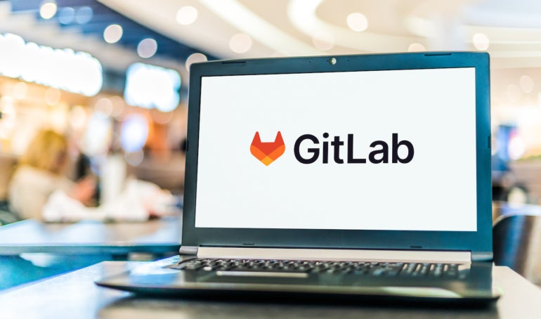 Laptop computer displaying logo of GitLab.