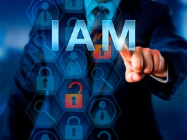 A business person tapping the word IAM.