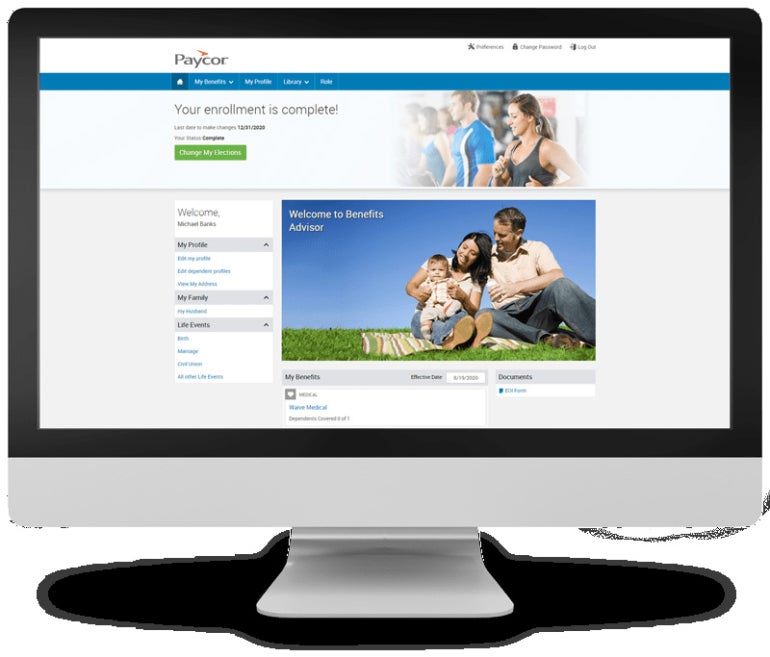 Monitor with Paycor open enrollment page displayed.