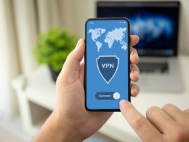 Man hands holding phone with app vpn on the screen.