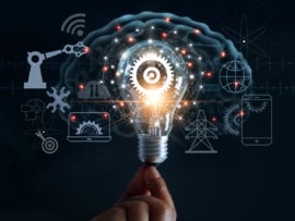 Hand holding light bulb and cog inside and innovation icon network connection on brain background.