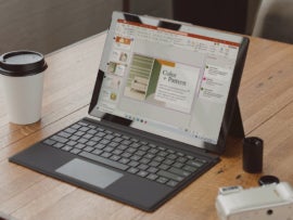 An open laptop with Microsoft PowerPoint on display.